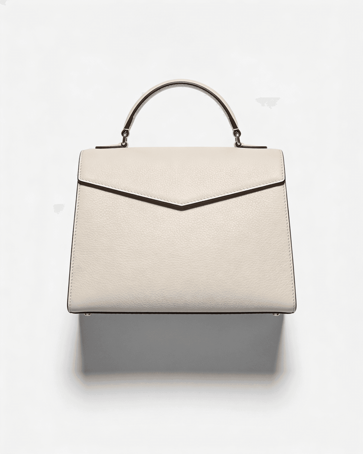 The Odile bag in chalk grained calfskin with an envelope flap and top handle