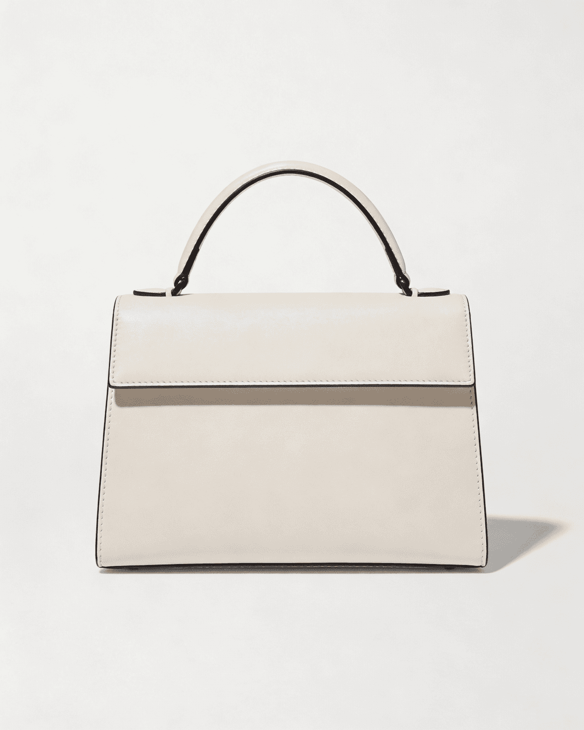 The small Odile bag in ivory box calfskin with a rolled top handle