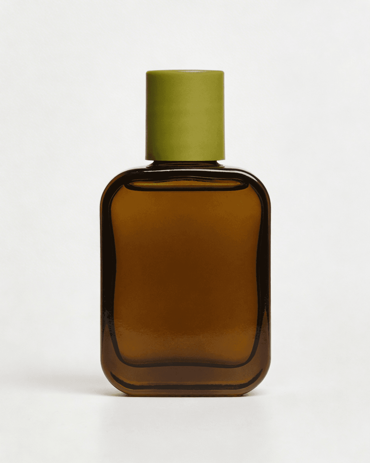 Amber glass perfume bottle with an olive green cap