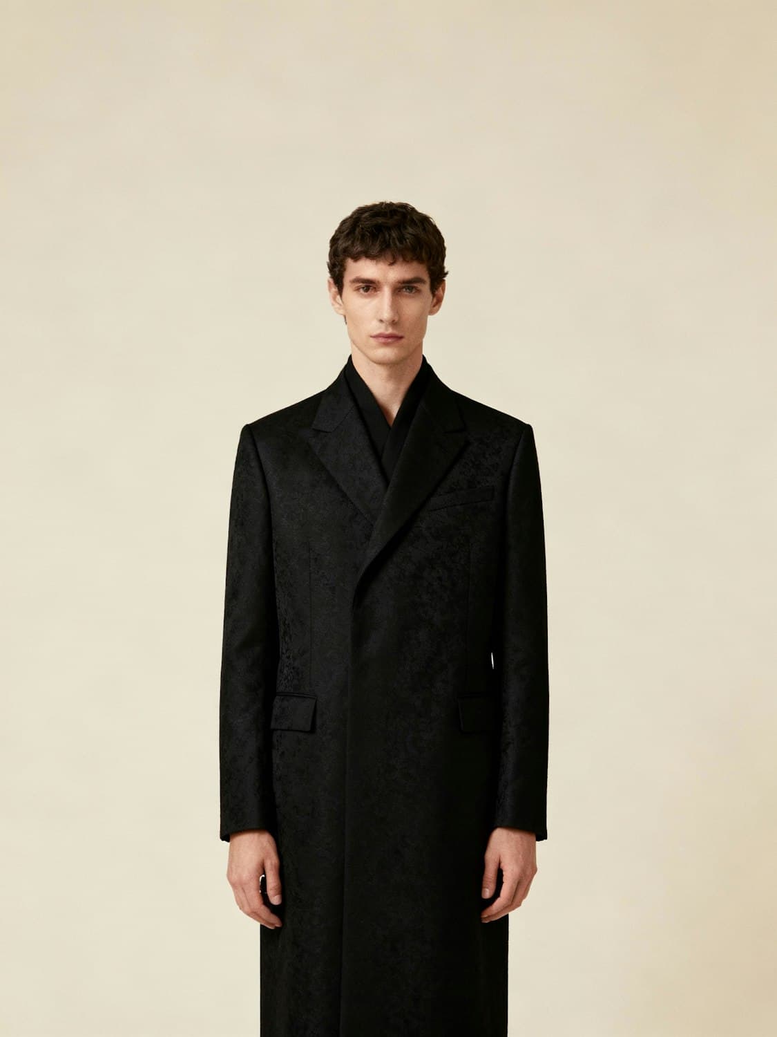 Model wearing the black Saint-Germain double-breasted jacquard overcoat